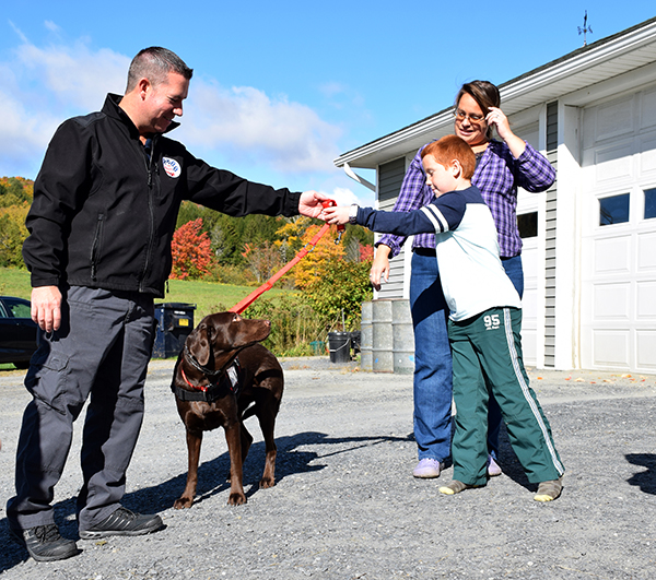 Aiden Heath meets his new service dog Angel. Photo: Jeff Knight